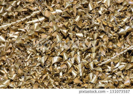 The pile of brass scrap materials from turning process. 131073587