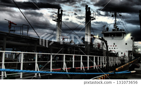 Man of the Sea! Cargo ship being loaded at night 131073656