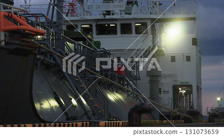Man of the Sea! Cargo ship being loaded at night Man of the Sea! Cargo ship being loaded at night 131073659