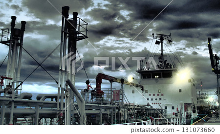 Man of the Sea! Cargo ship being loaded at night 131073660