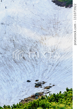 Snowboarders skiing down the large snowfields of Mount Hakuun 131073922