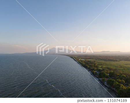 Natural landscape with volcano and lake shore Natural landscape with volcano and lake shore 131074189