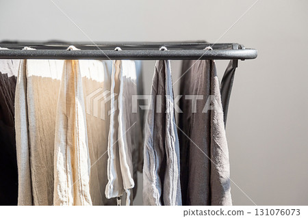 Laundry on drying rack indoors with natural light. Laundry on drying rack indoors with natural light. 131076073