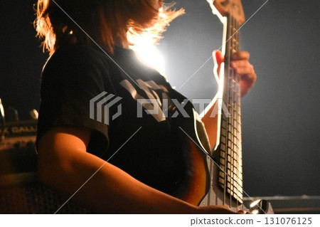 Female musician playing electric bass Female musician playing electric bass 131076125