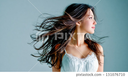 Profile portrait of a woman with beautiful hair blowing in the wind Profile portrait of a woman with beautiful hair blowing in the wind 131076710