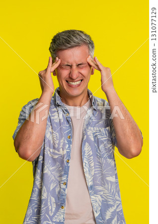 Adult man rubbing forehead with closed eyes suffering from strong headache pain visible discomfort Adult man rubbing forehead with closed eyes suffering from strong headache pain visible discomfort 131077129