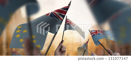 Tuvalu flags in their hands on a blurred urban background Tuvalu flags in their hands on a blurred urban background 131077147