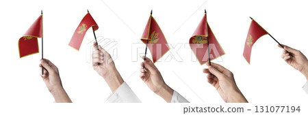The Montenegro flag in hand in different angles on a white background The Montenegro flag in hand in different angles on a white background 131077194