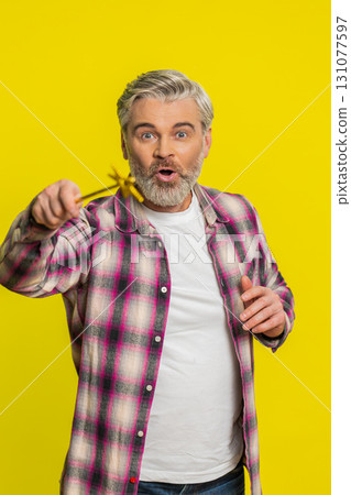 Magician witch Caucasian man gesturing with magic wand making wish come true, casting magician spell 131077597