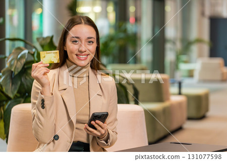 Businesswoman using credit bank card and smartphone, transferring money, purchases online shopping Businesswoman using credit bank card and smartphone, transferring money, purchases online shopping 131077598