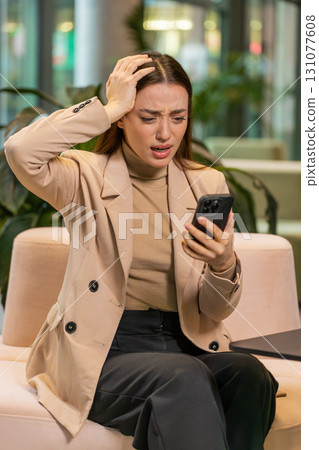 Caucasian business woman use smartphone surprised by bad news, fortune loss, fail, lottery results Caucasian business woman use smartphone surprised by bad news, fortune loss, fail, lottery results 131077608