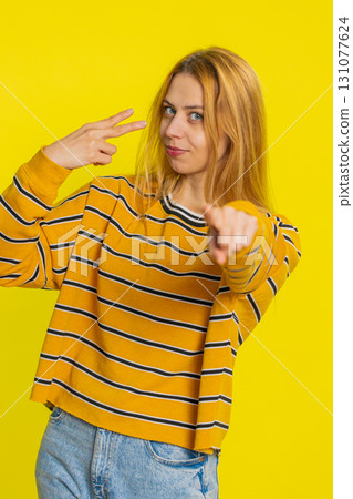 Young woman pointing at eyes and camera show I am watching you gesture spying, watching on someone Young woman pointing at eyes and camera show I am watching you gesture spying, watching on someone 131077624