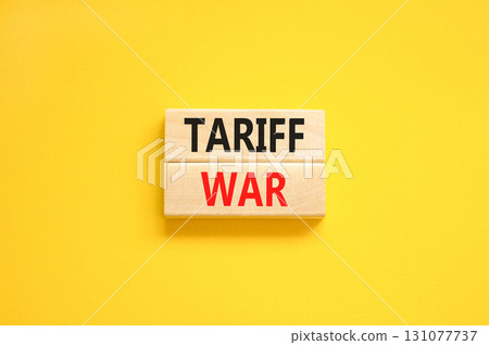 Trade tariff war symbol. Concept word Tariff war on beautiful wooden blocks. Beautiful yellow paper background. Business trade tariff wars concept. Copy space. 131077737