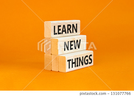 Learn new things symbol. Concept words Learn new things on beautiful wooden blocks. Beautiful orange table orange background. Business motivational learn new things concept. Copy space. 131077766