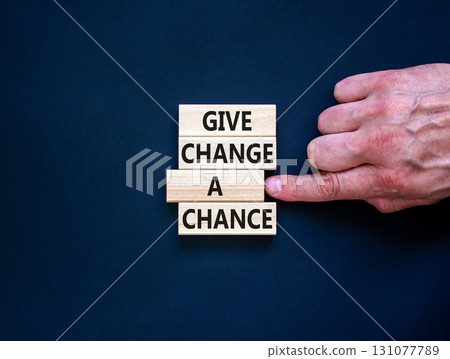 Give change a chance symbol. Concept words phrase Give change a chance on beautiful wooden blocks. Beautiful black paper background. Businessman's hand Business Give change a chance concept Copy space Give change a chance symbol. Concept words phrase Give change a chance on beautiful wooden blocks. Beautiful black paper background. Businessman's hand Business Give change a chance concept Copy space 131077789
