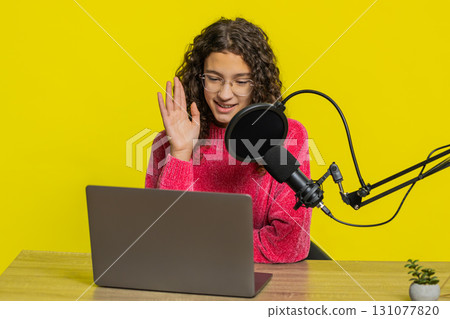 Girl blogger influencer recording podcast giving workshop webinar speaking in microphone and laptop Girl blogger influencer recording podcast giving workshop webinar speaking in microphone and laptop 131077820