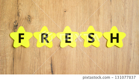 Fresh symbol. Concept word Fresh on beautiful yellow paper stars. Beautiful wooden table wooden background. Business lifestyle fresh concept. Copy space. 131077837