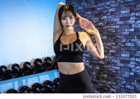 Posing well-trained woman, cool woman exercising in the gym, stretching, muscle training girl, center cropped 131077883