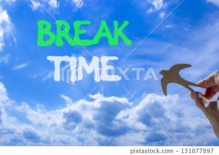 Break time symbol. Concept word Break time on beautiful blue sky. Businessman's hand with wooden bird. Beautiful blue sky and cloud background. Business break time concept. Copy space. Break time symbol. Concept word Break time on beautiful blue sky. Businessman's hand with wooden bird. Beautiful blue sky and cloud background. Business break time concept. Copy space. 131077897