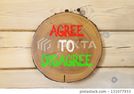 Agree to disagree symbol. Concept words Agree to disagree on beautiful wooden circle. Beautiful wooden wall background. Business and agree to disagree concept. Copy space. Agree to disagree symbol. Concept words Agree to disagree on beautiful wooden circle. Beautiful wooden wall background. Business and agree to disagree concept. Copy space. 131077933