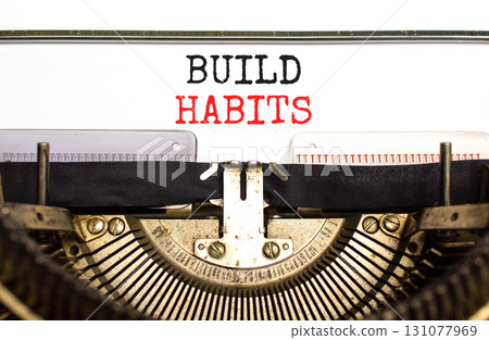 Build habits symbol. Concept word Build habits typed on beautiful old retro typewriter. Beautiful white paper background. Business build habits concept. Copy space. 131077969