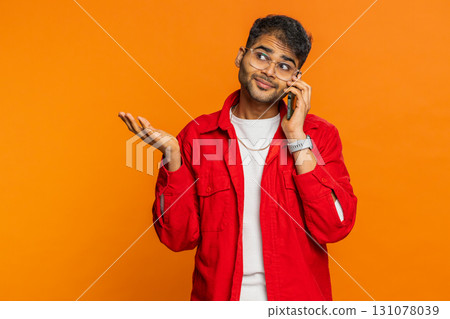 Disinterested tired Indian man having annoyed boring talk on smartphone online conversation, quarrel Disinterested tired Indian man having annoyed boring talk on smartphone online conversation, quarrel 131078039