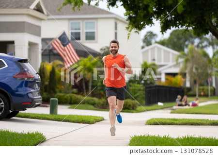Sport fit runner jogging. Jogging activity. Running man run down the neighborhood. Jogging man enjoy the freedom of running outdoor. Man runner running training during the run. Outdoor workout 131078528