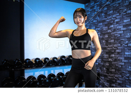 女人炫耀她的二頭肌,酷女人在健身房鍛煉,上身,肌肉訓練女孩 女人炫耀她的二頭肌,酷女人在健身房鍛煉,上身,肌肉訓練女孩 131078532