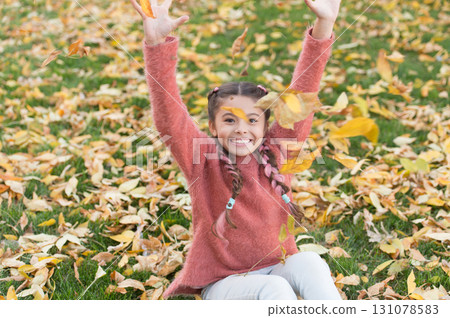 Small child with autumn leaves. Autumn leaves and nature. Happy childhood. School time. Happy little girl in autumn forest. So beautiful. Good mood at any weather. Going crazy. Feeling totally free 131078583