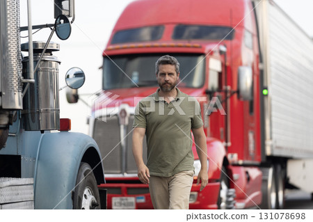 Handsome man driver in front of truck. Trucking owner. Truck driver. Man trucker driver near lorry truck. Transportation vehicles. Semi trucks vehicle. Hispanic man trucker. Lorry owner Handsome man driver in front of truck. Trucking owner. Truck driver. Man trucker driver near lorry truck. Transportation vehicles. Semi trucks vehicle. Hispanic man trucker. Lorry owner 131078698