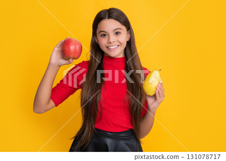 positive child hold apple and pear on yellow background positive child hold apple and pear on yellow background 131078717