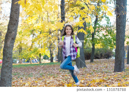 happy teenage girl having fun in autumn forest with beautiful seasonal nature carry school bag, leisure time happy teenage girl having fun in autumn forest with beautiful seasonal nature carry school bag, leisure time 131078788