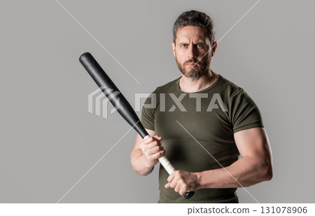angry man threatening, copy space. angry man express anger with bat isolated on grey angry man threatening, copy space. angry man express anger with bat isolated on grey 131078906
