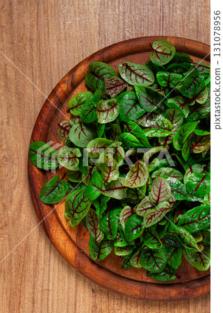 sorrel bloody Mary, fresh baby sorrel leaves, with red veins, micro-greens, on a plate, 131078956