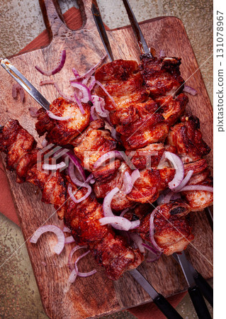 pork kebab on skewers, with red onion, on a wooden chopping board, close-up, top view, pork kebab on skewers, with red onion, on a wooden chopping board, close-up, top view, 131078967