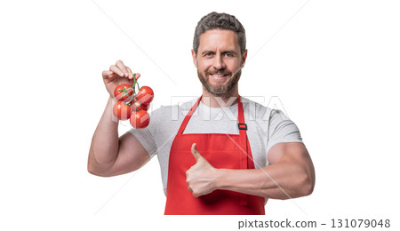 man in apron with tomato vegetable isolated on white. thumb up man in apron with tomato vegetable isolated on white. thumb up 131079048