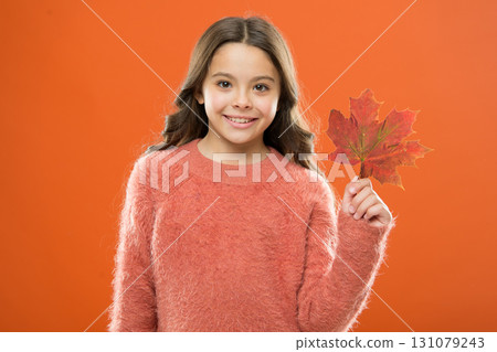 Maple syrup. Little child hold maple leaf. Small girl smiling with maple leaf. Maple syrup is often used as condiment for pancakes waffles oatmeal or porridge. Ingredient in baking and sweetener 131079243