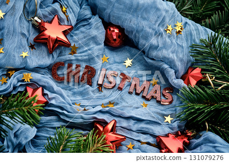 Blue fabric background with the inscription Christmas for your congratulations. 131079276