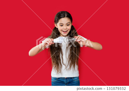 positive teen girl has solution in studio. teen girl has solution on background. positive teen girl has solution in studio. teen girl has solution on background. 131079332