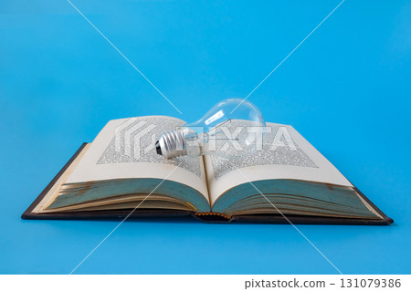 A light bulb on old books , Idea of learning, Education concept. A light bulb on old books , Idea of learning, Education concept. 131079386