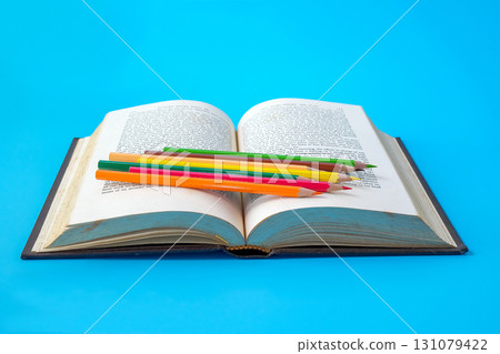 Bright color pencils on old books. 131079422