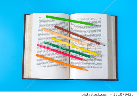 Bright color pencils on old books. Bright color pencils on old books. 131079423
