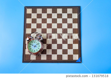 Alarm clock on chessboard ,strategy and time concept 131079518
