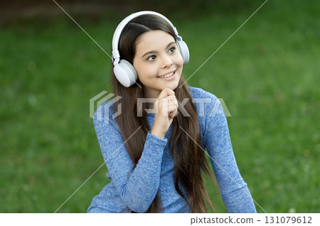 Teen girl listen music in wireless headphones. Gen z lifestyle. Style of music. Stylish teen girl listen music. School student lifestyle. Listen audio. Music lifestyle. Pondering girl outdoor Teen girl listen music in wireless headphones. Gen z lifestyle. Style of music. Stylish teen girl listen music. School student lifestyle. Listen audio. Music lifestyle. Pondering girl outdoor 131079612