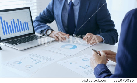 Businesspeople colleagues are reviewing financial data, analyzing charts and graphs, pointing at laptop screen during corporate meeting. Business people and finance concept Businesspeople colleagues are reviewing financial data, analyzing charts and graphs, pointing at laptop screen during corporate meeting. Business people and finance concept 131079880