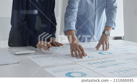 Professional business team analyzing financial reports, sharing insights and planning strategic decisions in modern office Professional business team analyzing financial reports, sharing insights and planning strategic decisions in modern office 131080095