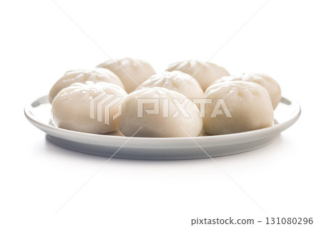 Xiao long bao. Chinese dumplings on plate isolated on white background. Xiao long bao. Chinese dumplings on plate isolated on white background. 131080296