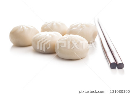 Xiao long bao. Chinese dumplings and chopsticks isolated on white background. 131080300