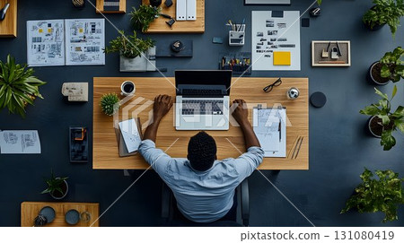Overhead View of a Modern Workspace with a Laptop and Greenery 131080419