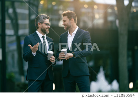 Colleague have business meeting. Business of businesspeople. Coffee break. Businesspeople outdoor. Business colleague at coffee break. Businesspeople talking with coffee cup. Boss and employee Colleague have business meeting. Business of businesspeople. Coffee break. Businesspeople outdoor. Business colleague at coffee break. Businesspeople talking with coffee cup. Boss and employee 131080594